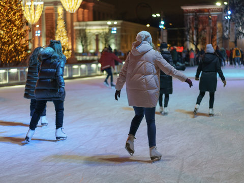 Ice Skating Rink In City Park. Men And Women, Children, Youth And Middle-aged People Skate And Get Fun. Lifestyles Concepts. View From Above / Top View. Rear View