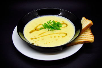 Leek cream soup on black background