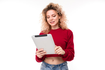 European girl reads messages on a tablet on a white background
