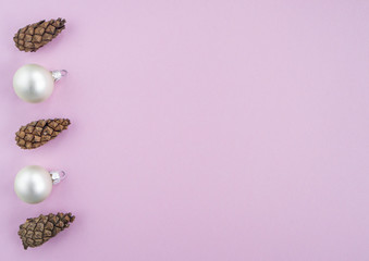 Christmas New year flat lay with pine tree, silver ball and branch on pink background. Greeting card, top view, copy space. 