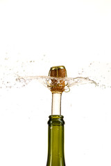 opening a bottle of champagne, cork flyes out of the bottle with splashes