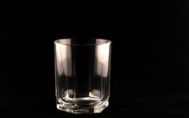 Hexagonal glass for alcoholic beverages on a black background.