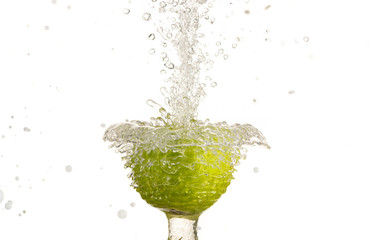 An apple hanging in a stream of water fountain