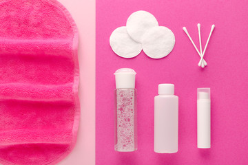 make up remove products, micellar water, face cleaning cloth, cleansing milk and gel with cotton pads on pink background
