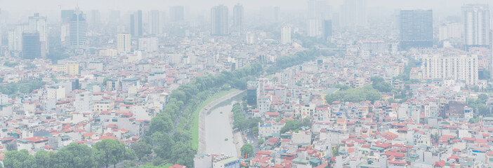 Panoramic top view high-density housing along To Lich River in Hanoi, Vietnam foggy day
