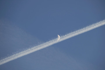 cloud of fog and moon, moon and airplane in the sky, fog cloud formed by the aircraft,