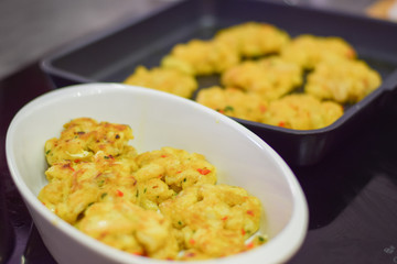 Fish cakes in the dish and frying fan