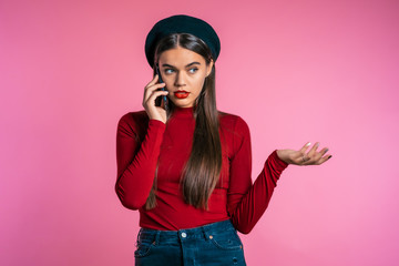 Woman with pretty appearance sort things out, swears with somebody by mobile phone. Girl nervous, expresses discontent, resentment. does not understand what happening