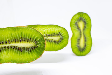 Kiwi sliced in slices on a white background. fruits seem to soar in the air.