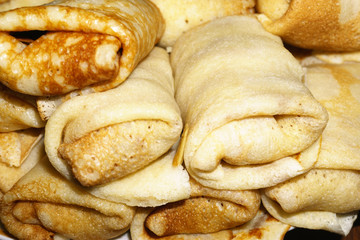 Hearty and tasty breakfast or lunch. Thin fried pancakes with lamb meat close-up. Maslenitsa.