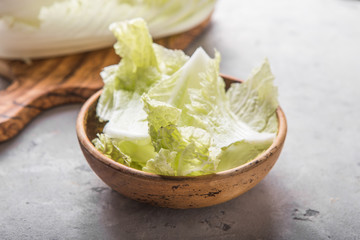 Peking fresh chinese cabbages in wood bowl on a white background. top view. Vegetarian, slimming, diet food concept. Flat lay