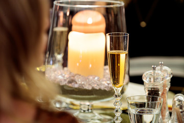 Closeup shot of a champagne glass on a luxury table setting with a blurred background