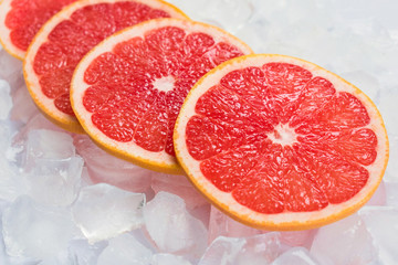  Grapefruit slices on ice. Close-up.