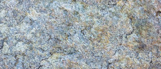 Granite texture. Granite rocks with porous surface. Background from solid stone. Pattern with natural material. Widescreen