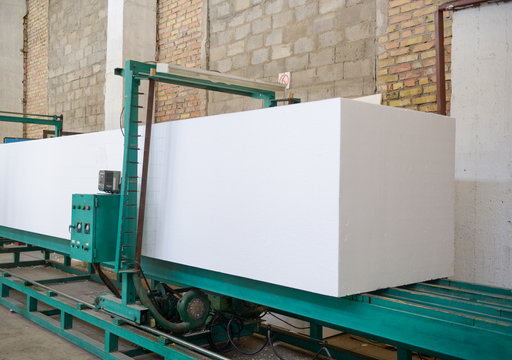 The machine cuts foam plastic. Plant for the production of sandwich panels from styrofoam