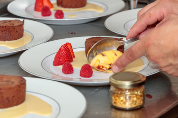 Closeup shot of a person making a delicious dessert with berries and cream