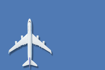 Airplane model and text space on blue background