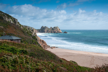 Obraz premium View of Porthcurno Beach in south Cornwall on a cloudy September day.