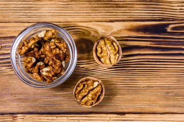 Cores of walnut in glass bowl on a wooden table. Top view