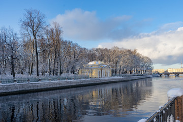 Beautiful snowy city promenade with an old bridge on a sunny winter day. St. Petersburg, Swan groove.