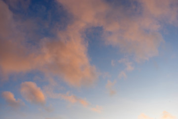 Naklejka na ściany i meble Beautiful sky background with tender pink sunset clouds.