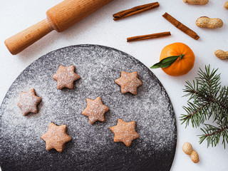 Homemade Christmas shortbread star shape sugar cookies with sugar powder, cinnamon, green fir tree...