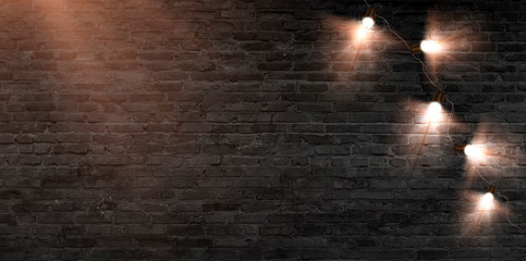 Brick wall with a garland of lanterns. Brick wall background, festive look.