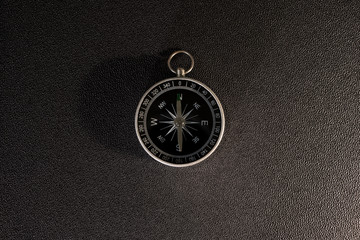 compass on a black shaggy background points north