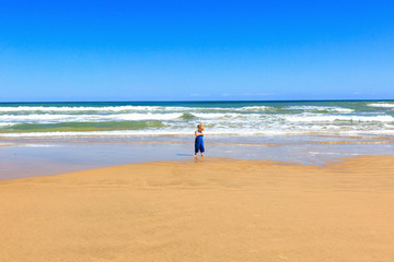 Little baby have fun on the beach.