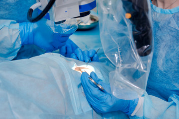 Close up of surgery team operating. The operation on the eye. Cataract surgery. Laser vision...