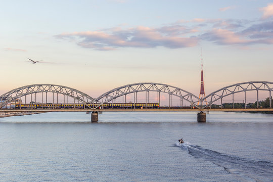 Latvia, Riga, railway bridge and TV Tower at the Daugava River in the evening