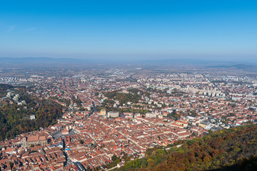 Brasov city seen from the Tampa mountain on a fall day. landscape shoot with mountain blurred on the background and the city buildings in front of the screen