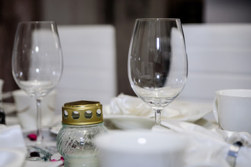 Elegant decoration of table in a restaurant. Porcelain plates, silver cutlery and crystal glasses.