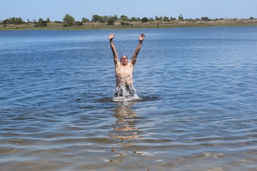 man jumping on the beach