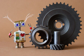 Funny robot mechanic or serviceman with hand wrench and gears.