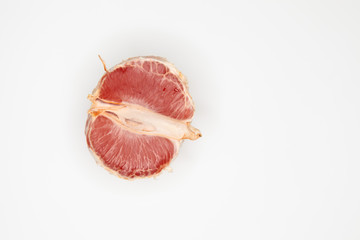 Half of the grapefruit is lying on a white background
