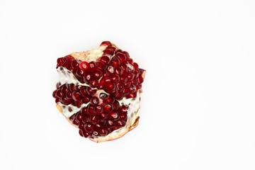 Ripe pomegranate is lying on a white background