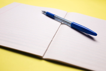 school notebook with pen on background