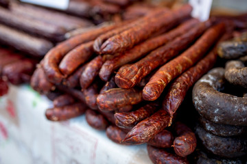 Food stand with smoked homemade sausages on street market