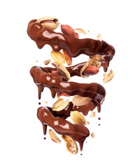 Chocolate splashes in spiral shape with crushed peanuts, isolated on a white background