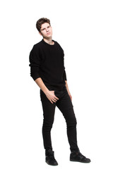 Young male model in black clothes posing in studio white background. Caucasian guy in stylish clothes sweater and jeans isolate. Fashion model young white man