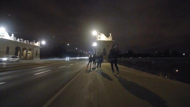 Night inline skating on bridge