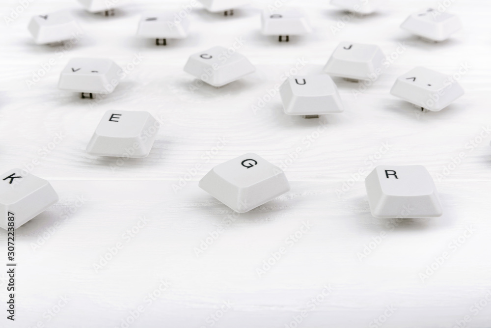 Fototapete keyboard keys isolated. white keyboard keys on white wooden background. top view. close up