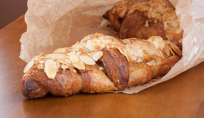 Fresh almond crescent in a paper bag