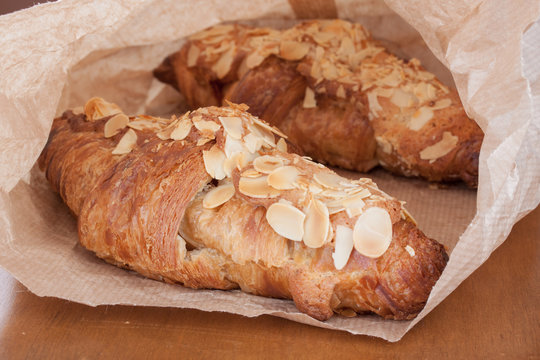 Fresh delicious golden almond crescent in paper bag