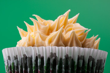 Close-up on delicious sweet cupcake, green background