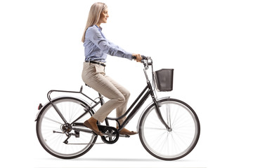 Young woman in formal clothes riding a bicycle