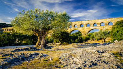 The Pont du Gard, an ancient Roman aqueduct, crossing the  river Gardon in Southern France with an...