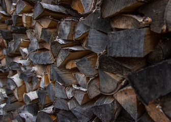 Chopped firewood background, texture. Logs stacked and prepared for winter.  Heating season, winter season.