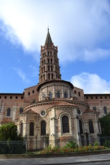 Fototapeta na wymiar Basilica of Saint-Sernin in Toulouse: view of the altar and bell tower from the side of Saint-Bernard street